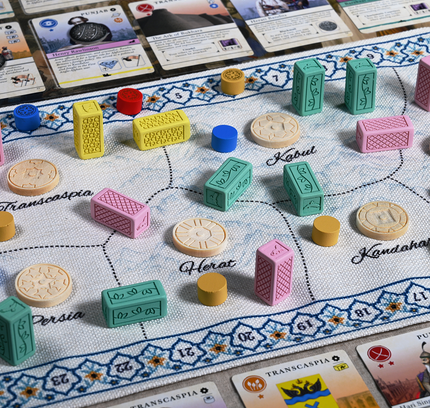 Cloth map of Pax Pamir: Second Edition shown with Resin dominance blocks and wooden ruler tokens.
