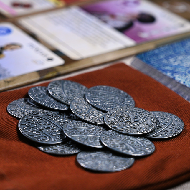 A close-up of the metal coins add-on for Pax Pamir.