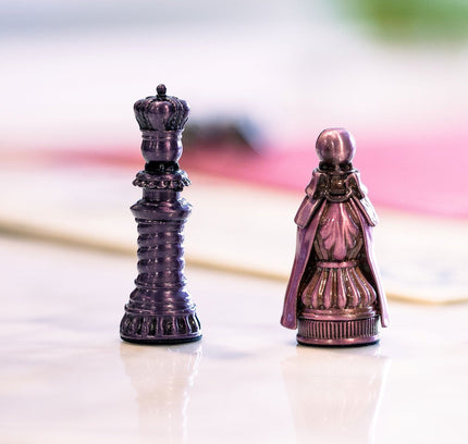 Two of the five metal pawns used for Molly House
