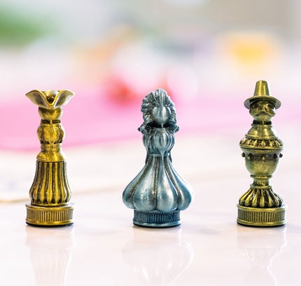 Three of the five metal pawns used for Molly House
